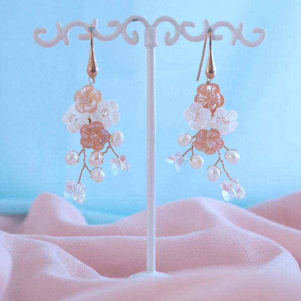 Bespoke earrings with mother-of-pearl flowers and Swarovski crystal butterflies